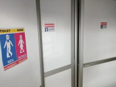 a door with signs on the side of a elevator at Carlos Guest House 3 Cusco in Cusco