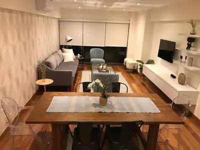 a living room with a table and a couch at MLA apartments - Buenos Aires in Lima