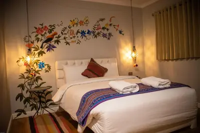 a bedroom with a bed with towels on it at Home Garden Hotel in Cusco