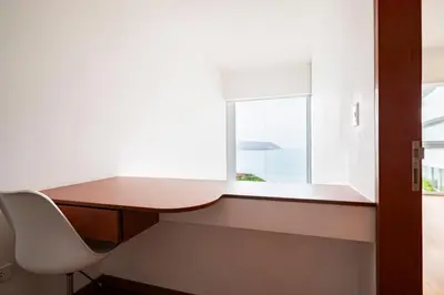 a desk and a chair in a room with a window at InkaHuset Miraflores Oceanfront in Lima