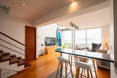 a kitchen and living room with a table and chairs at InkaHuset Miraflores Oceanfront in Lima