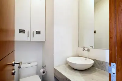 a bathroom with a sink and a toilet and a mirror at InkaHuset Miraflores Oceanfront in Lima