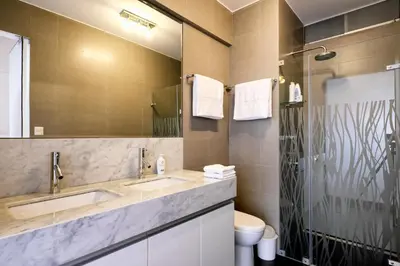 a bathroom with two sinks and a mirror at InkaHuset Miraflores Oceanfront in Lima