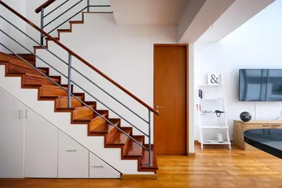 a staircase in a home with white walls and wooden floors at InkaHuset Miraflores Oceanfront in Lima