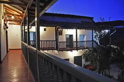 a balcony of a house with a fence and lights at La Estación San Pedro in Cusco