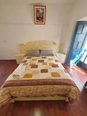 a bed in a room with a wooden floor at La Estación San Pedro in Cusco