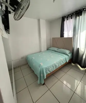 a small bed in a room with a window at Hospedaje Senegal cerca al aeropuerto in Lima