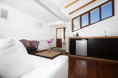 a living room with a white couch and a table at Tocuyeros Boutique Hotel in Cusco