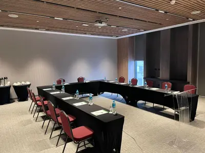 a conference room with a long table and red chairs at Holiday Inn - Lima Miraflores by IHG in Lima