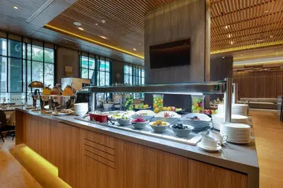 a buffet line with plates and bowls of food at Holiday Inn - Lima Miraflores by IHG in Lima