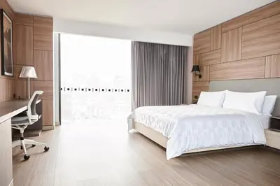 a hotel room with a bed and a desk and a window at Holiday Inn - Lima Miraflores by IHG in Lima