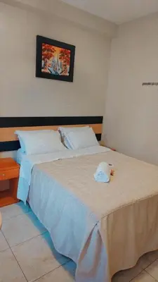 a bedroom with a bed with a towel on it at Hostal Parisuite in Lima