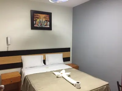 a room with a bed with a cross on it at Hostal Parisuite in Lima