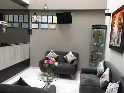 a living room with two couches and a table at Hostal Parisuite in Lima