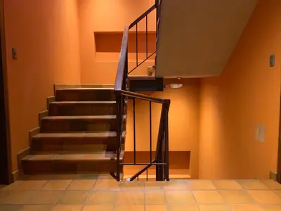a staircase in a room with orange walls at 1911 in Machu Picchu