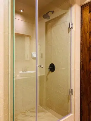 a glass shower door with a sink in a bathroom at 1911 in Machu Picchu