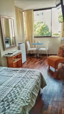 a hotel room with a bed and a table and chairs at Amplia habitación con baño in Lima