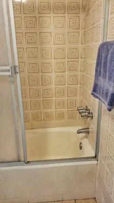 a shower with a glass door in a bathroom at Amplia habitación con baño in Lima