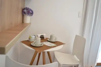 a small table and chairs in a small room at Katari Apart Hotel at Qorikancha in Cusco
