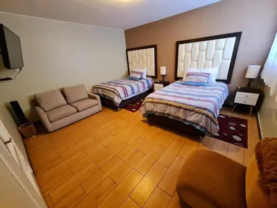 a living room with two beds and a couch at Miraflores Dpto 2 dorm. espaciosos 4 huéspedes 90m2 in Lima