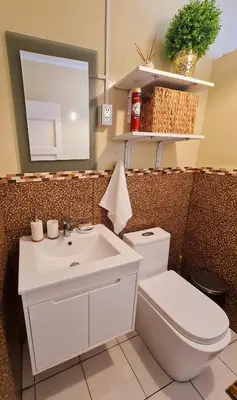 a bathroom with a white toilet and a sink at Miraflores Dpto 2 dorm. espaciosos 4 huéspedes 90m2 in Lima