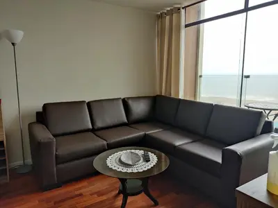 a living room with a couch and a table at Blue Coast Lima apart Peru in Lima