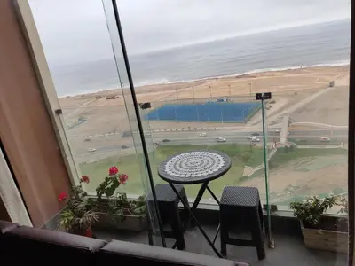 a balcony with a table and a view of a runway at Blue Coast Lima apart Peru in Lima