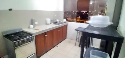 a kitchen with a counter with a cake on it at Blue Coast Lima apart Peru in Lima