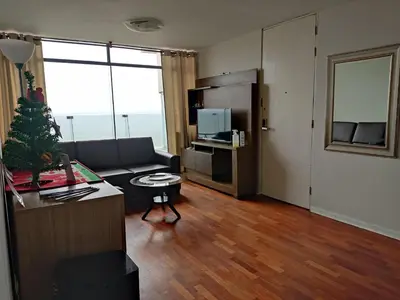 a living room with a couch and a table at Blue Coast Lima apart Peru in Lima