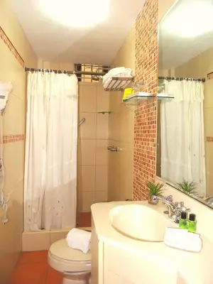 a bathroom with a sink and a toilet and a mirror at Lima Wari Hotel Boutique in Lima