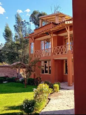 a large house with a balcony on top of it at Allin Illary Eco Hospedaje in Urubamba