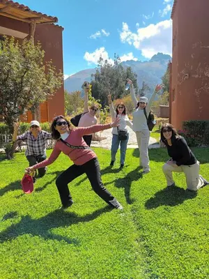 a group of people playing frisbee in the grass at Allin Illary Eco Hospedaje in Urubamba