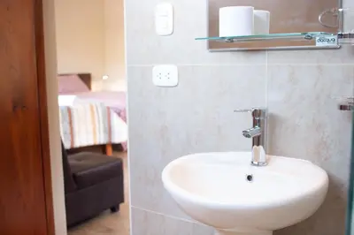a bathroom with a sink and a chair at Allin Illary Eco Hospedaje in Urubamba
