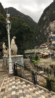 two statues of sheep on a bridge with a street light at Hotel Machupicchu Inn in Machu Picchu