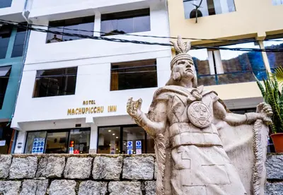a statue in front of a building at Hotel Machupicchu Inn in Machu Picchu