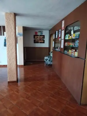 a lobby of a fast food restaurant with a cash register at Hostal Turístico El Cajamarquez in Lima