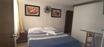 a bedroom with a bed with two towels on it at Hostal Turístico El Cajamarquez in Lima