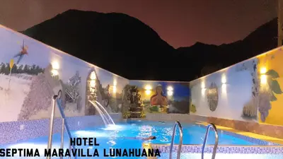 a large hot tub in a hotel with a mountain mural at Hotel Septima Maravilla Lunahuana in Lunahuaná