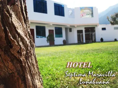 a view of a building from behind a tree at Hotel Septima Maravilla Lunahuana in Lunahuaná