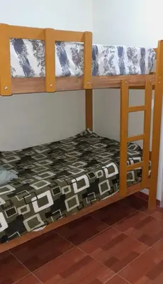 a bedroom with two bunk beds in a room at Hospedaje Arana in Chincha Alta