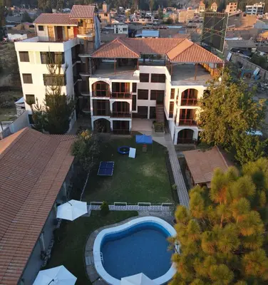 an aerial view of a house with a swimming pool at Llamita Hotel-Huancayo in Huancayo