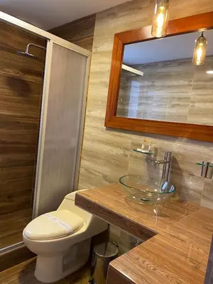 a bathroom with a toilet and a sink and a mirror at Llamita Hotel-Huancayo in Huancayo