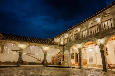 a courtyard of a colonial building at night at Llamita Hotel-Huancayo in Huancayo