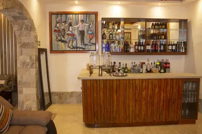 a bar in a room with a lot of alcohol at Llamita Hotel-Huancayo in Huancayo