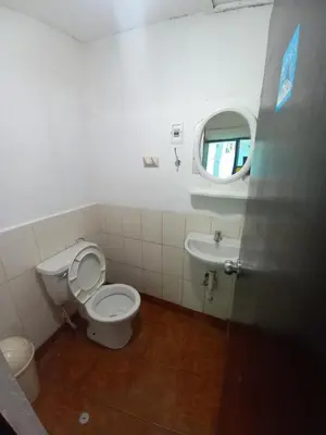 a bathroom with a toilet and a sink at Imperial Golden House Inn in Cusco