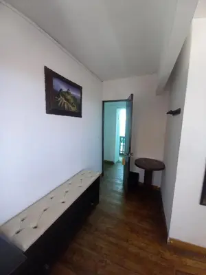 a room with a bed and a table in it at Imperial Golden House Inn in Cusco