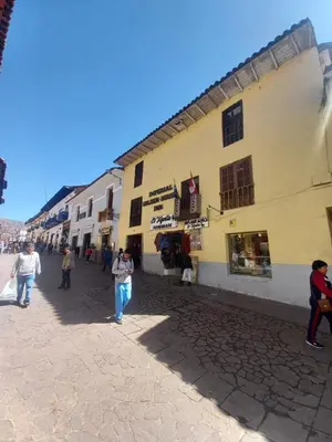 a group of people walking down a street at Imperial Golden House Inn in Cusco
