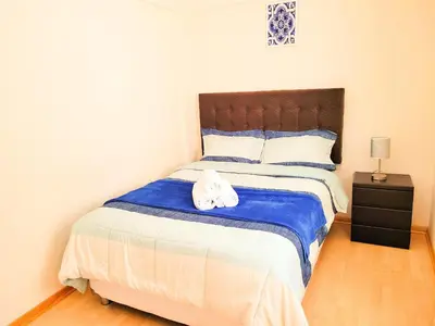a bedroom with a large bed with towels on it at Fiflos Apartament in Cusco