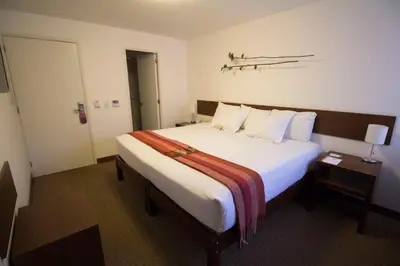 a bedroom with a large white bed with white pillows at Tierra Viva Miraflores Larco in Lima