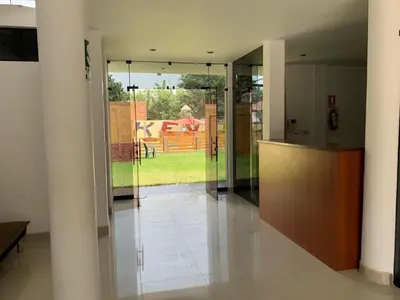 a hallway with glass doors and a view of a yard at Keylas Hotel in Ica